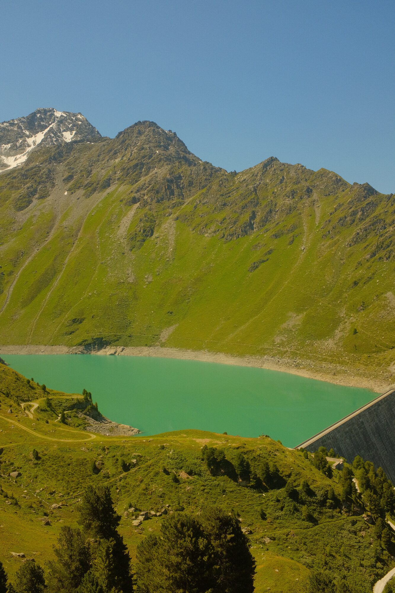 Turquoise Lac de Cleuson and its dam wall above Siviez, Valais